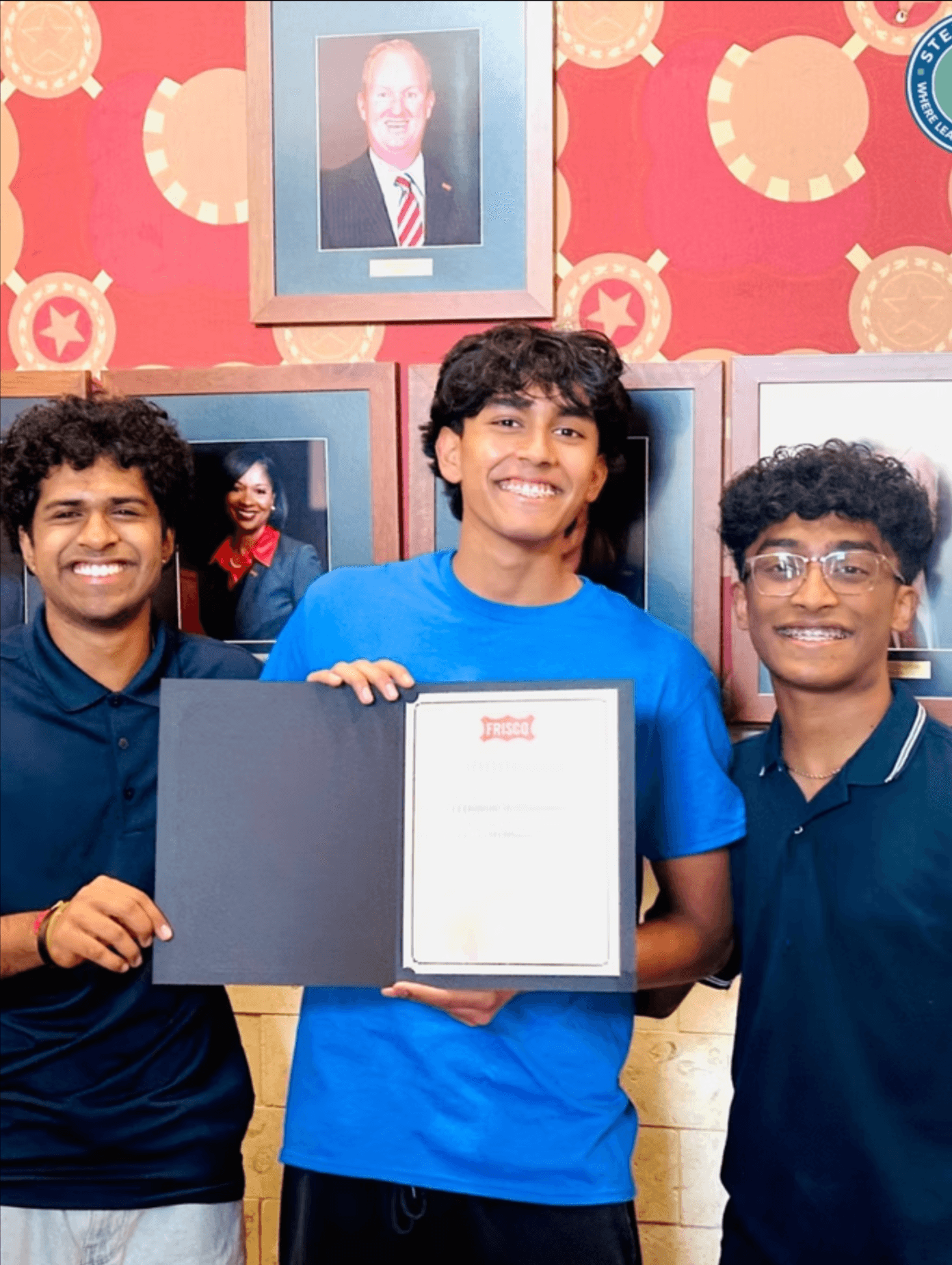 STEMSeeds students holding a Frisco certificate of recognition