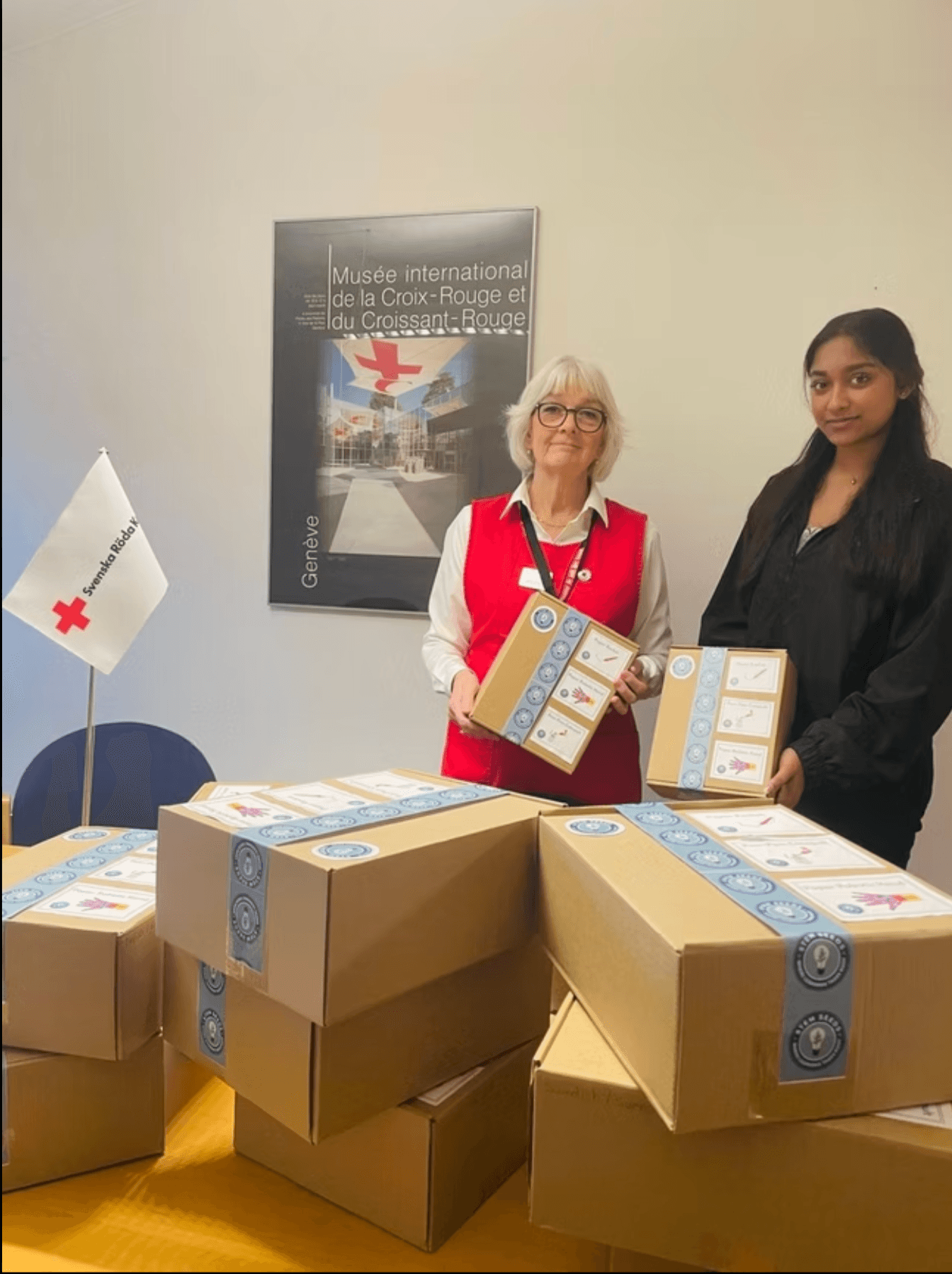 A STEMSeeds volunteer delivering kits with a Swedish Red Cross partner