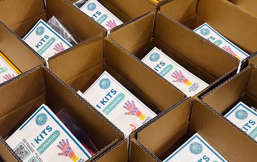 Open kit boxes packed with STEM Kits instruction manuals