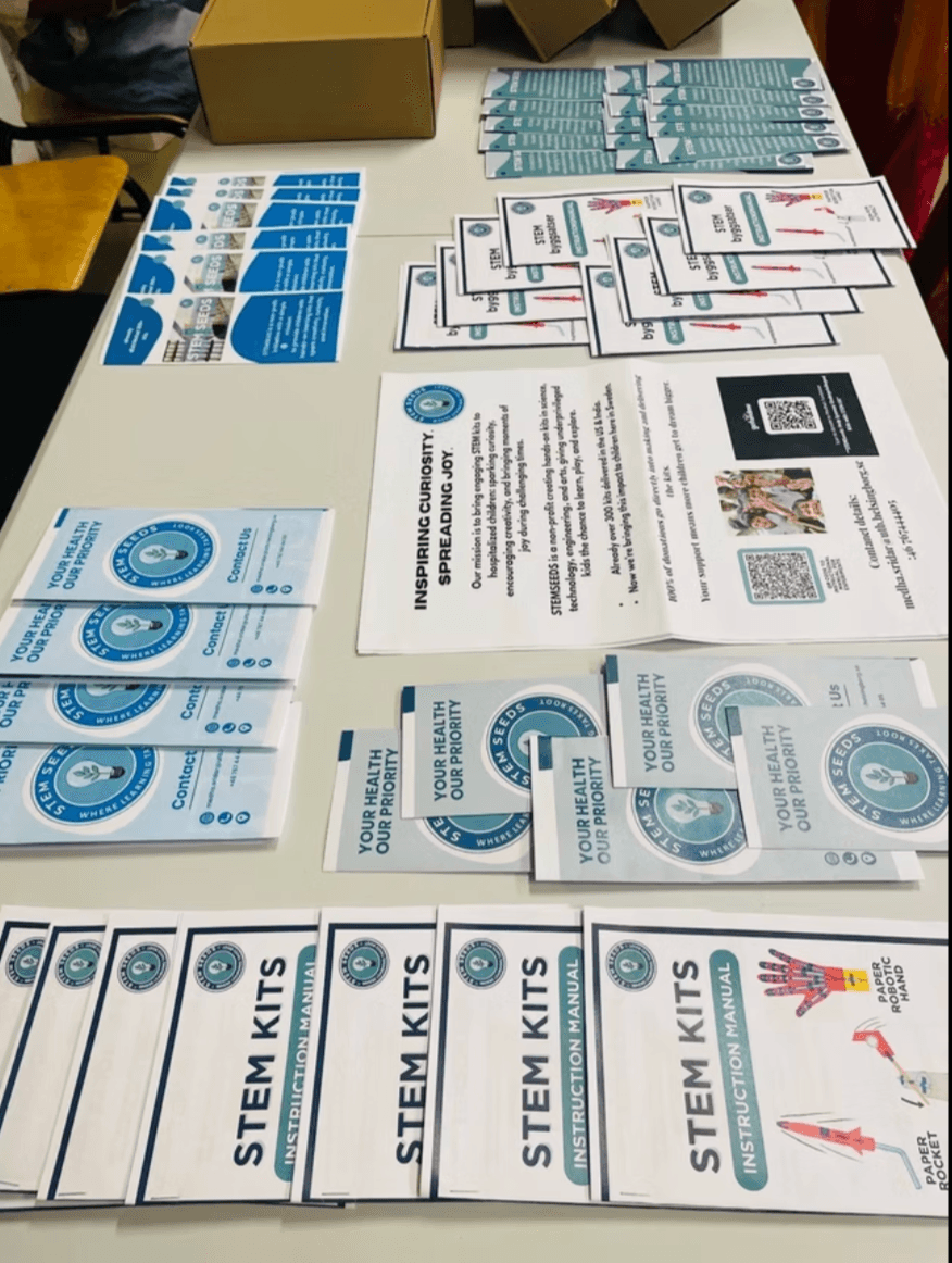 Manuals, educational flyers, and health cards laid out for kit assembly
