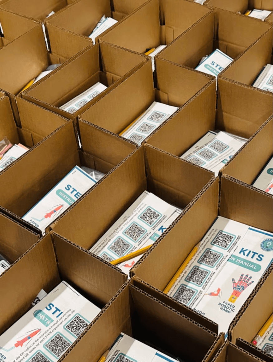 Open kit boxes filled with instruction manuals and pencils